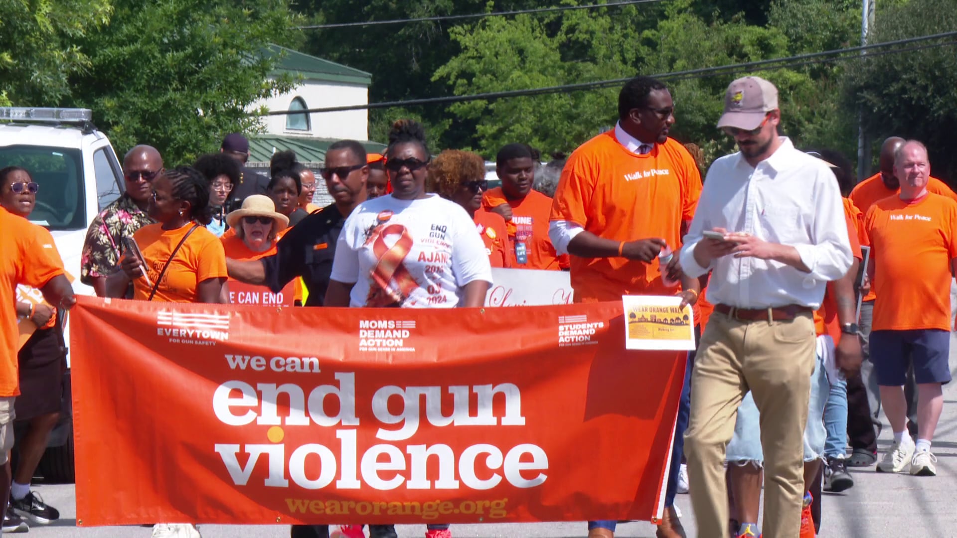 Community members walk to raise awareness against gun violence