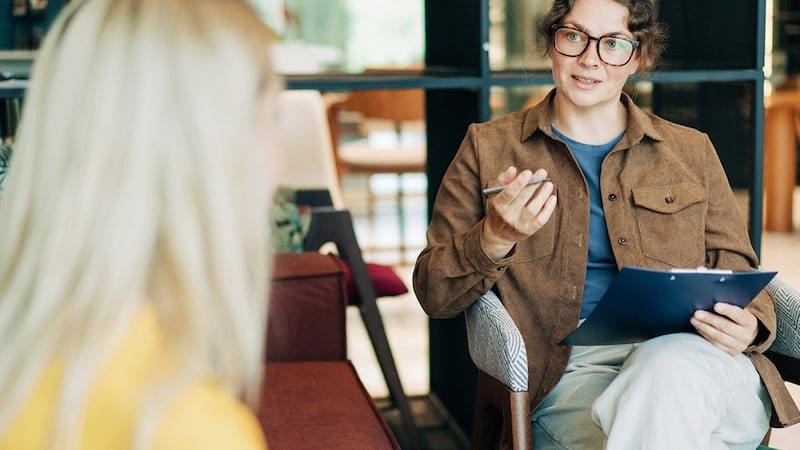 A psychologist advising a patient during a therapy session.