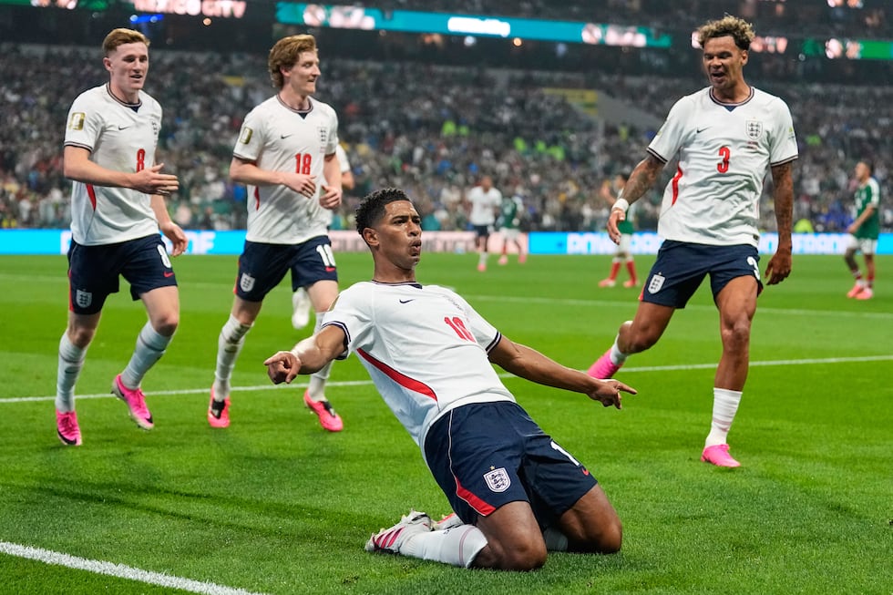England's Jude Bellingham (10) celebrates with teammates after scoring his second goal during...