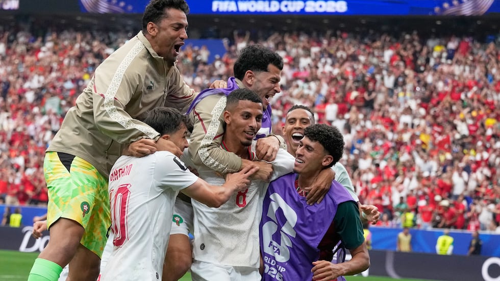 Morocco's Azzedine Ounahi, center, is congratulated by teammates after scoring his side's 2nd...