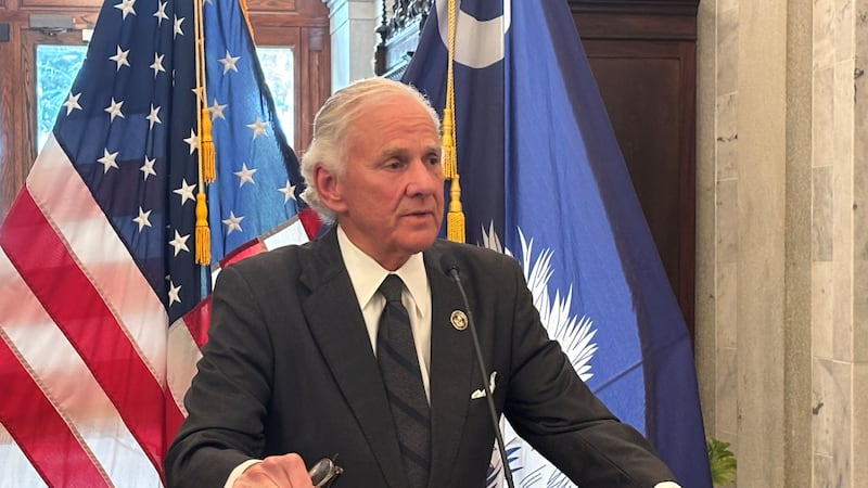Gov. Henry McMaster speaks with reporters outside his office in the South Carolina State House...