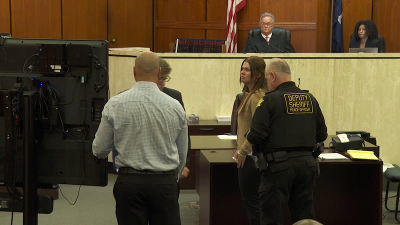 Madeline Kuester listens to 911 call in court.
